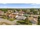 Aerial view of a residential neighborhood with houses and palm trees at 16967 Se 93Rd Cuthbert Cir, The Villages, FL 32162