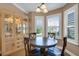 Charming dining area with wood hutch and window seating at 16967 Se 93Rd Cuthbert Cir, The Villages, FL 32162