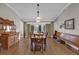 Dining room with hardwood floors, wooden table, and antique buffet at 16967 Se 93Rd Cuthbert Cir, The Villages, FL 32162