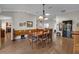 Dining room with hardwood floors, wooden table, and bench at 16967 Se 93Rd Cuthbert Cir, The Villages, FL 32162