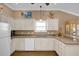 Kitchen features white cabinets, granite counters, and a large sink at 16967 Se 93Rd Cuthbert Cir, The Villages, FL 32162