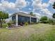 Screened patio and landscaped backyard with lush greenery at 5911 Delphina Loop, The Villages, FL 32163