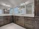 Elegant bathroom with double vanity and dark brown cabinets at 5911 Delphina Loop, The Villages, FL 32163