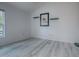 Empty bedroom with wood-look floors and a large window at 5911 Delphina Loop, The Villages, FL 32163