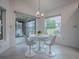 Bright breakfast nook with white table and four chairs, overlooking a backyard view at 5911 Delphina Loop, The Villages, FL 32163