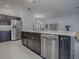 Modern kitchen with stainless steel appliances and dark wood cabinetry at 5911 Delphina Loop, The Villages, FL 32163