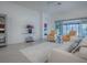 Bright living room with white sofa and two armchairs, overlooking the lake at 5911 Delphina Loop, The Villages, FL 32163