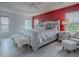 Spacious main bedroom with plush bed, red accent wall, and ample natural light at 5911 Delphina Loop, The Villages, FL 32163