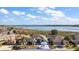 Aerial view of a house with a lake view at 10173 Lake Miona Way, Oxford, FL 34484