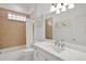 Clean bathroom, featuring a bathtub and quartz countertop at 10173 Lake Miona Way, Oxford, FL 34484