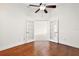 Spacious bedroom with hardwood floors and French doors at 10173 Lake Miona Way, Oxford, FL 34484