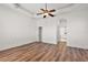 Spacious bedroom with hardwood floors and access to bathroom at 10173 Lake Miona Way, Oxford, FL 34484