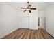 Well-lit bedroom with hardwood floors and double closet at 10173 Lake Miona Way, Oxford, FL 34484