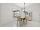 Light and airy dining room with chandelier and built-in hutch at 10173 Lake Miona Way, Oxford, FL 34484