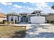 Two-story house with a two-car garage at 10173 Lake Miona Way, Oxford, FL 34484