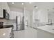 Modern kitchen with stainless steel appliances and white cabinets at 10173 Lake Miona Way, Oxford, FL 34484