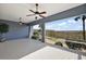 Peaceful screened porch with lake view and ceiling fans at 10173 Lake Miona Way, Oxford, FL 34484