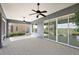 Spacious screened porch with paver floor and ceiling fans at 10173 Lake Miona Way, Oxford, FL 34484