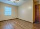 Bright bedroom with wood-look floors and neutral walls at 1029 Cr 452A, Lake Panasoffkee, FL 33538