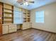 Home office with built-in shelving and wood-look floors at 1029 Cr 452A, Lake Panasoffkee, FL 33538