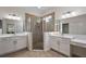 Elegant bathroom with double vanities and a large walk-in shower at 10377 Silver Maple Ave, Oxford, FL 34484