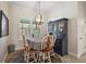 Charming dining room with a farmhouse table and hutch at 10377 Silver Maple Ave, Oxford, FL 34484