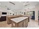 Large kitchen island with granite countertops and pendant lighting at 10377 Silver Maple Ave, Oxford, FL 34484