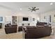 Spacious living room with leather sofas and a built-in entertainment center at 10377 Silver Maple Ave, Oxford, FL 34484