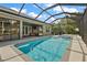 Inviting screened pool and patio with sliding glass doors leading to the interior at 10377 Silver Maple Ave, Oxford, FL 34484