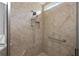 Walk-in shower with tiled walls and built-in seat at 10377 Silver Maple Ave, Oxford, FL 34484