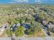 Aerial view showing a house nestled among lush green trees in a residential neighborhood at 1101 Lantana Dr, Eustis, FL 32726