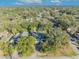 Aerial view of a single-Gathering home with a large backyard and surrounding trees at 1101 Lantana Dr, Eustis, FL 32726