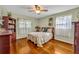 Bedroom with hardwood floors, ceiling fan, and a queen-size bed at 1101 Lantana Dr, Eustis, FL 32726