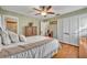 Bedroom featuring hardwood floors, ceiling fan, and white built-in closet at 1101 Lantana Dr, Eustis, FL 32726