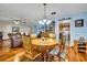 Bright dining room with wood table and chairs, hardwood floors, and view into kitchen at 1101 Lantana Dr, Eustis, FL 32726