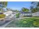 Single-story house with a two-car garage and a well-maintained lawn at 1101 Lantana Dr, Eustis, FL 32726