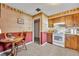 Cozy kitchen nook with wood cabinets and white appliances at 1101 Lantana Dr, Eustis, FL 32726