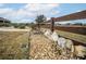 Wooden fence with landscaping and gravel at 11189 Roz Way, Oxford, FL 34484