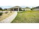 Brick walkway leading to the backyard patio area at 11189 Roz Way, Oxford, FL 34484