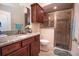 Clean bathroom with a shower, toilet, and granite countertop at 11189 Roz Way, Oxford, FL 34484