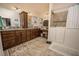 Elegant bathroom with a walk-in shower and double vanity at 11189 Roz Way, Oxford, FL 34484