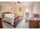 Cozy bedroom with a comfortable bed and plenty of light at 11189 Roz Way, Oxford, FL 34484