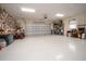 Spacious garage with epoxy flooring and overhead storage at 11189 Roz Way, Oxford, FL 34484