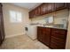 Laundry room featuring built-in cabinets and granite countertop at 11189 Roz Way, Oxford, FL 34484