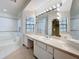 Elegant bathroom with a large vanity, soaking tub and a walk-in shower at 1130 Elysium Blvd, Mount Dora, FL 32757