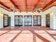 Hexagonal terracotta tile floor, wood ceilings, ceiling fans, and French doors at 1130 Elysium Blvd, Mount Dora, FL 32757