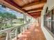 Long covered walkway with terracotta tile flooring and white columns at 1130 Elysium Blvd, Mount Dora, FL 32757