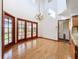 Sunlit dining room with hardwood floors and French doors at 1130 Elysium Blvd, Mount Dora, FL 32757