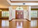 Bright and airy entryway with hardwood floors and elegant double doors at 1130 Elysium Blvd, Mount Dora, FL 32757