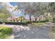 Home exterior showcasing a red tile roof and lush landscaping at 1130 Elysium Blvd, Mount Dora, FL 32757